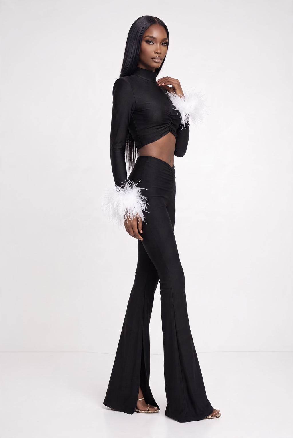 The Saint 54 fitted black crop top with polo neckline, shoulder pads, and detachable white ostrich feather cuffs.