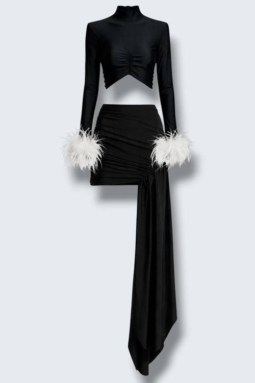 The Saint 54 Miss Rose black two-piece set with polo neckline, gathered details, and detachable white ostrich feathers.