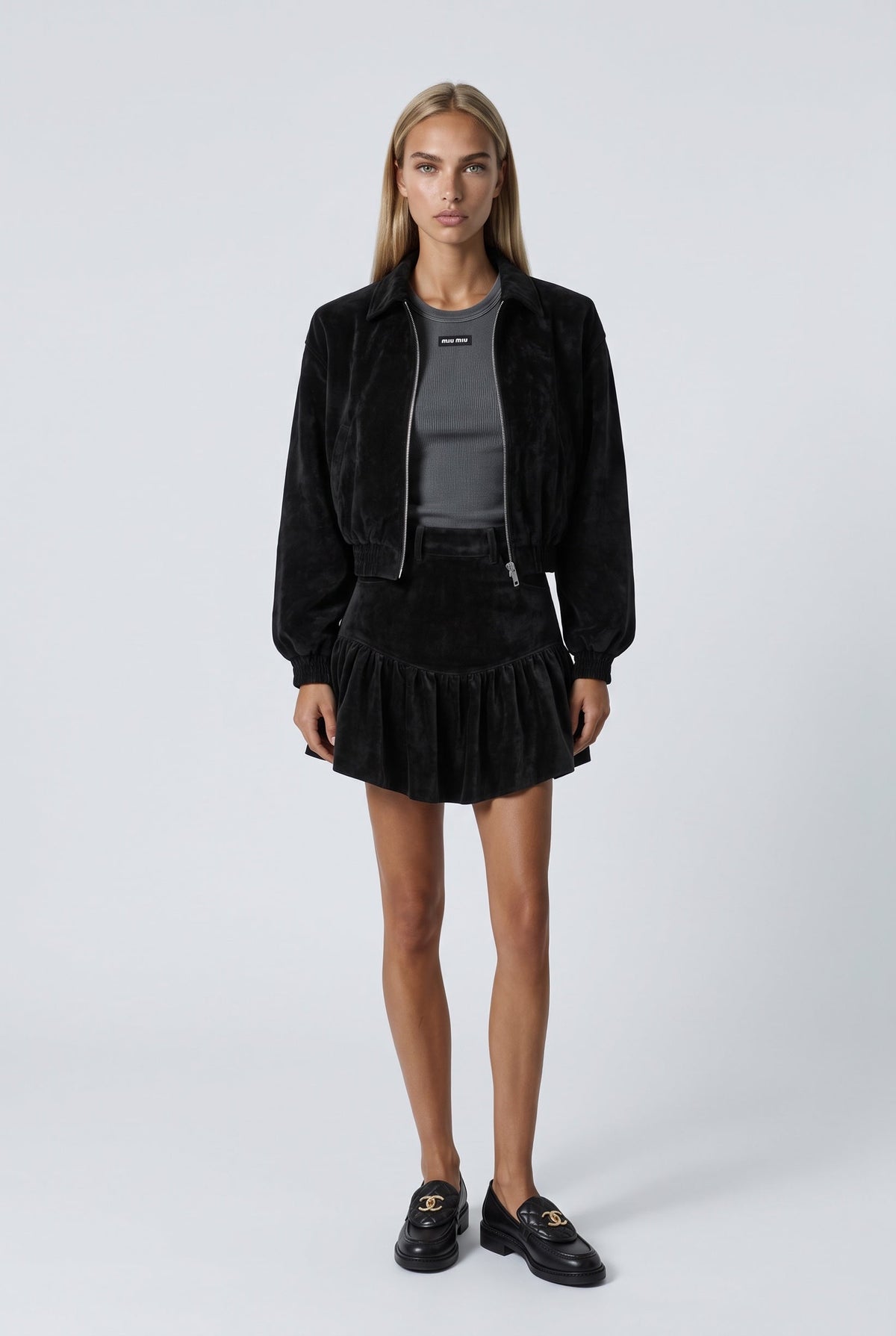 The Saint 54 black suede bomber jacket with an oversize fit, shoulder pads, and satin lining worn by a model.