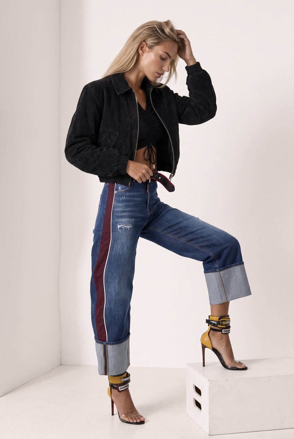 The Saint 54 black suede bomber jacket with an oversize fit, shoulder pads, and satin lining worn by a model.