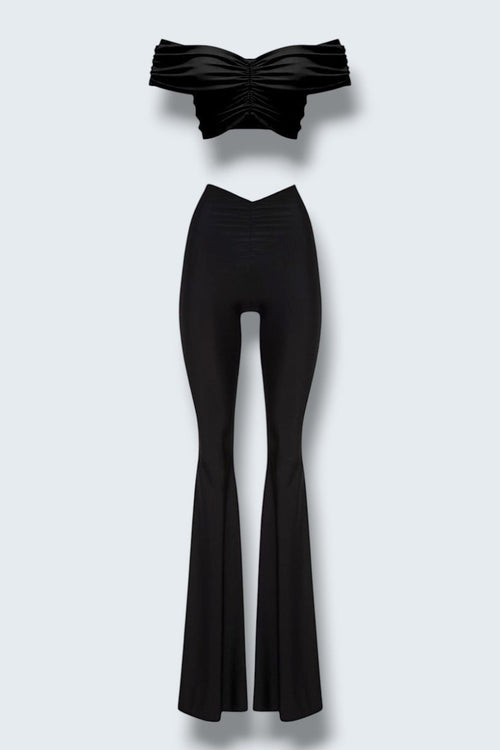 The Saint 54 black two-piece set with a cropped off-shoulder top and flared trousers featuring gathered details.